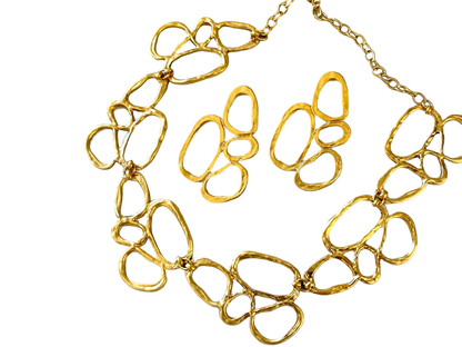 a gold necklace is shown on a black background