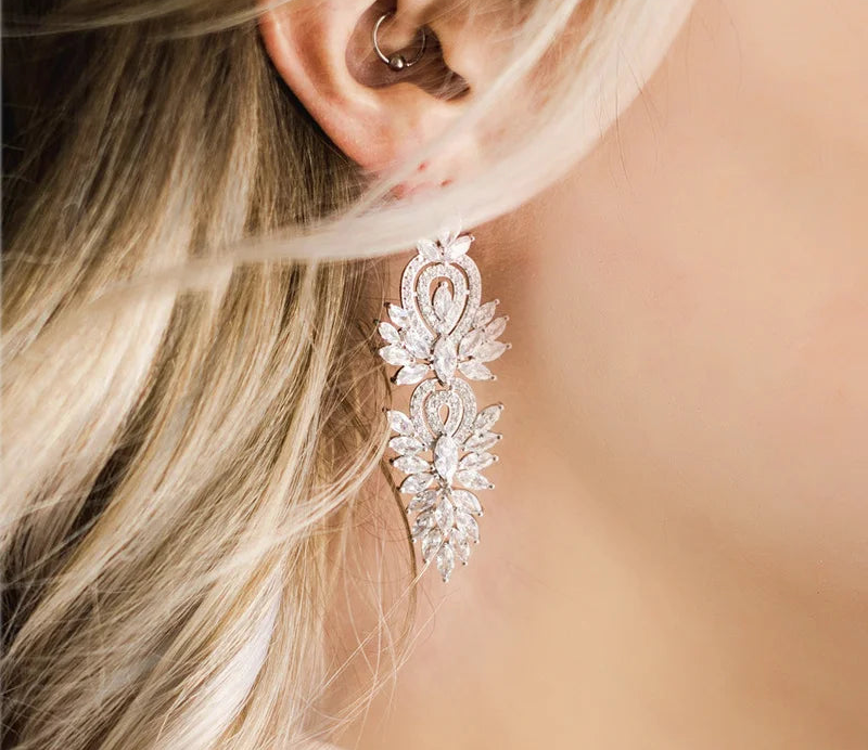 a close up of a person wearing a pair of earrings