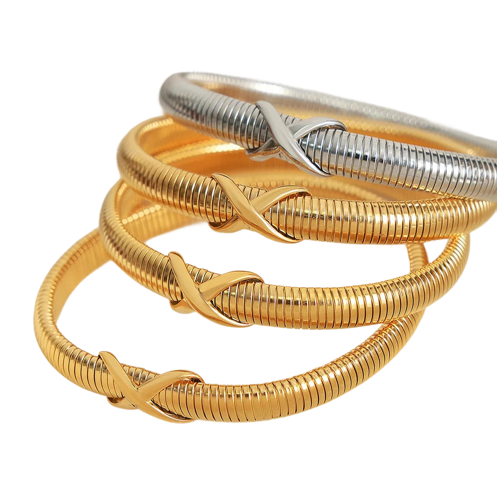 a stack of gold and silver rings on a black background