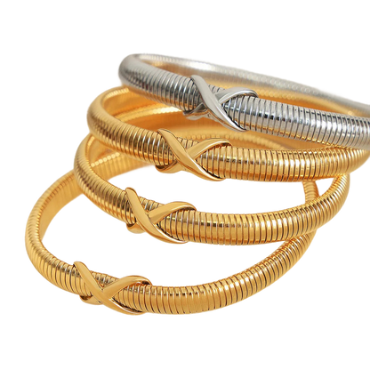 a stack of gold and silver rings on a black background