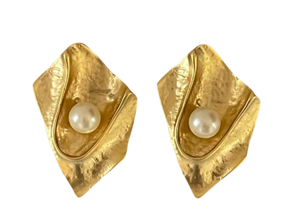 a pair of gold earrings with a pearl