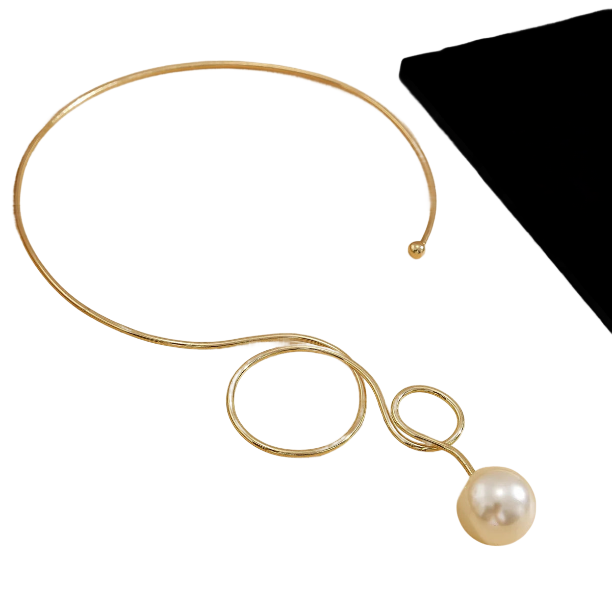 a gold necklace with a pearl on a black background