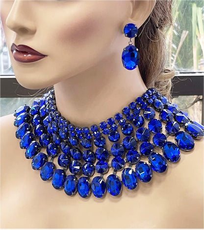 a woman wearing a blue necklace and earrings