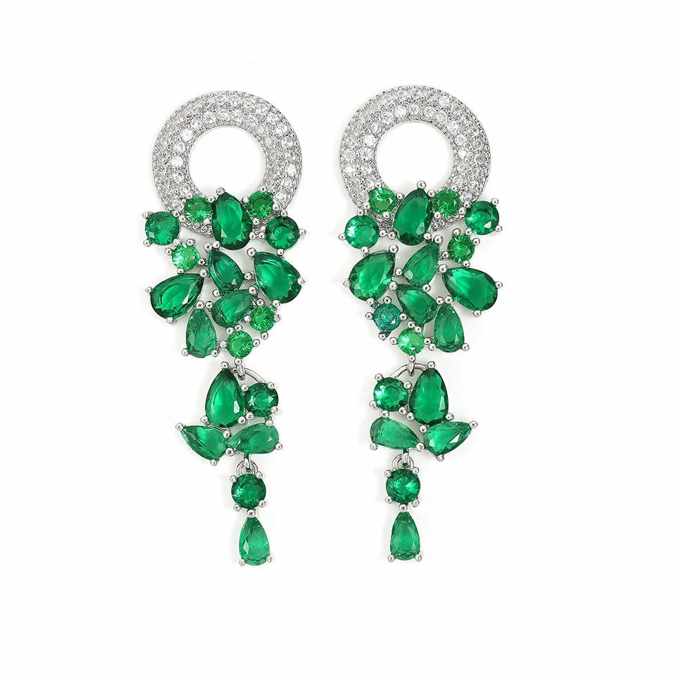 a pair of green and white crystal earrings