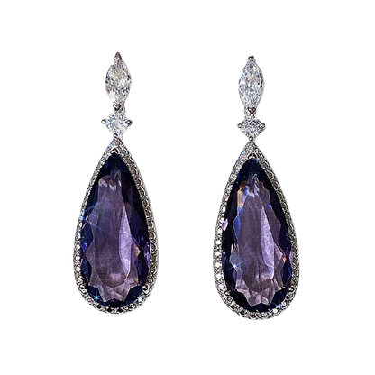 a pair of earrings with purple stones and diamonds