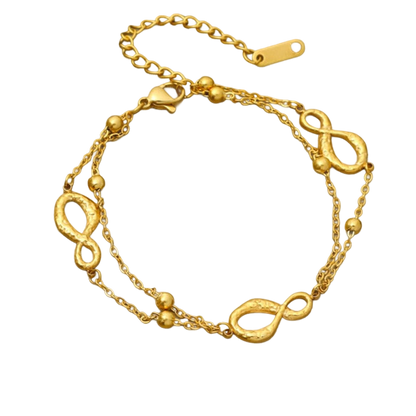 a gold bracelet with a knot on it