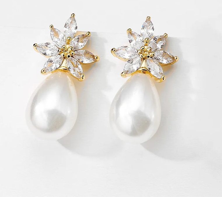 a pair of pearl and diamond earrings