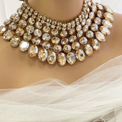 a woman wearing a wedding dress with a large necklace on her neck