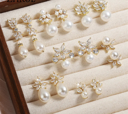 a bunch of pearl and crystal brooches