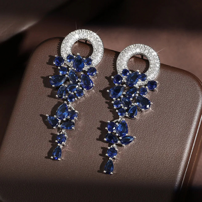 a pair of blue and white diamond earrings