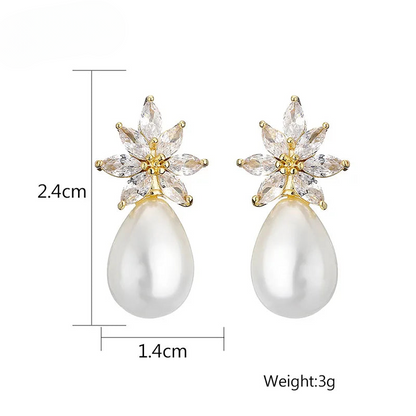 a pair of pearl and crystal earrings