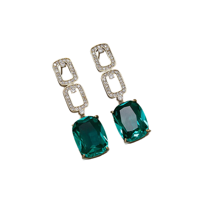 a pair of emerald and diamond earrings