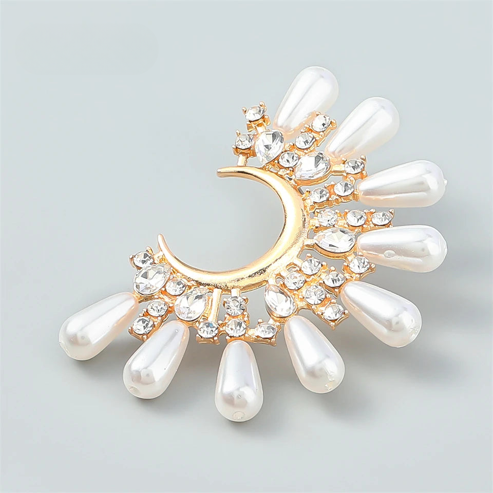 a brooch with pearls and a crescent