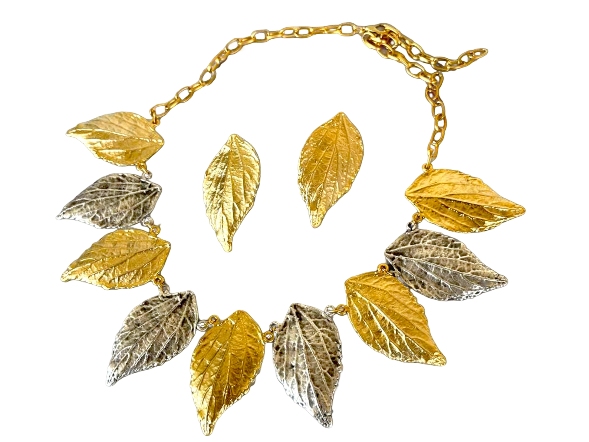 a gold and silver necklace with leaves on it