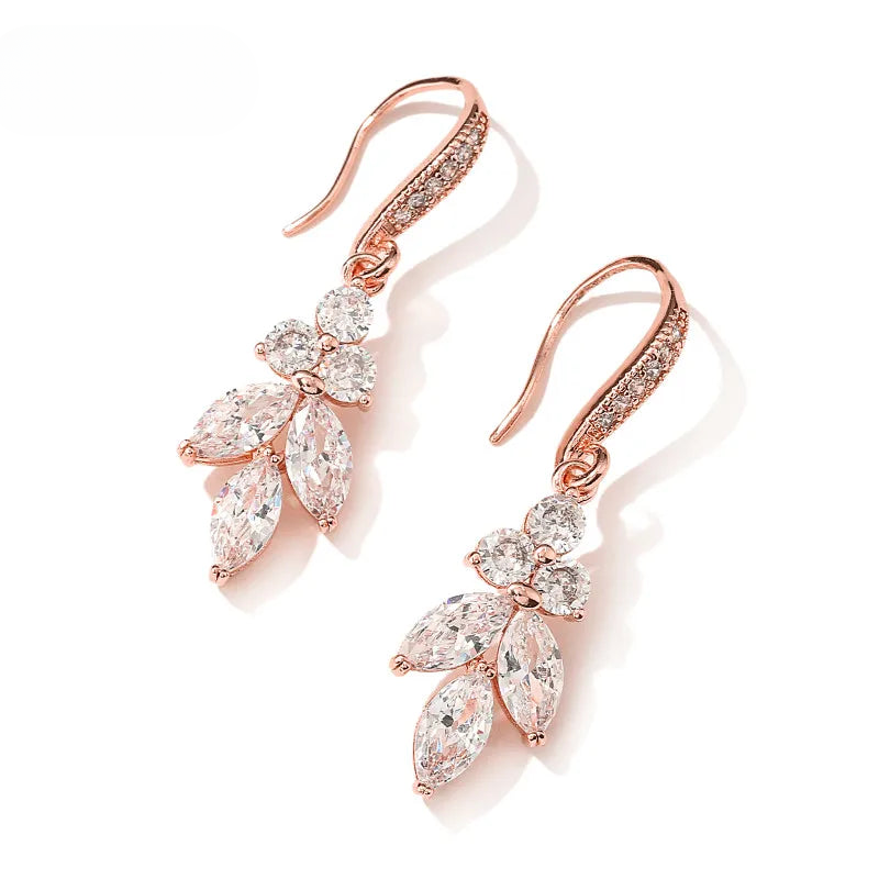 a pair of rose gold earrings with clear stones