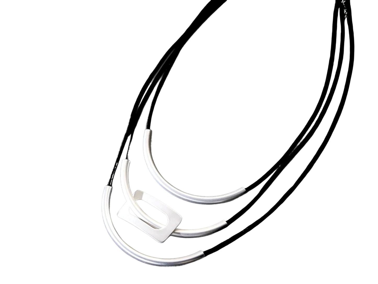 a black and white photo of three necklaces