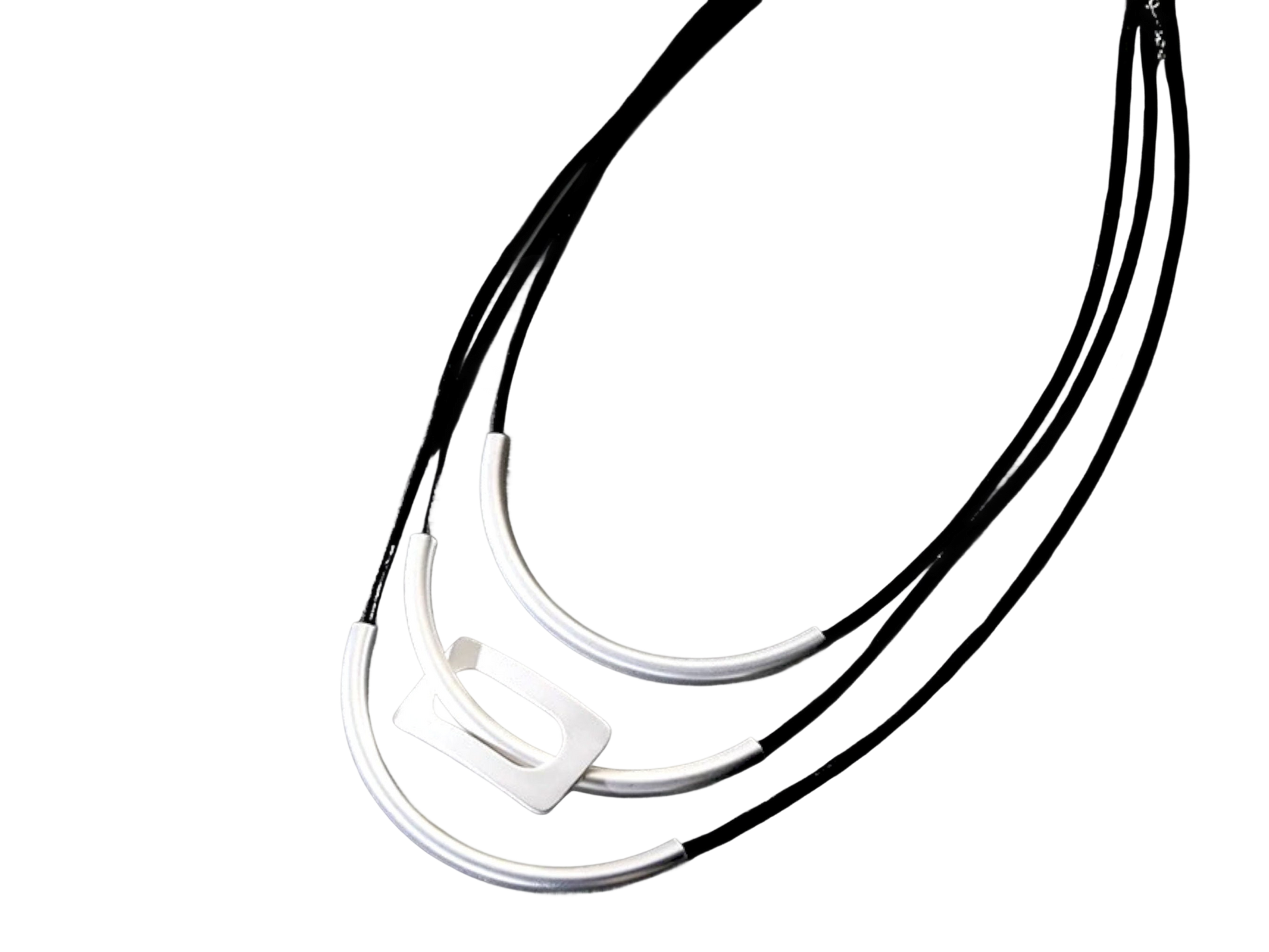 a black and white photo of three necklaces