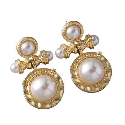 a pair of gold and pearl earrings