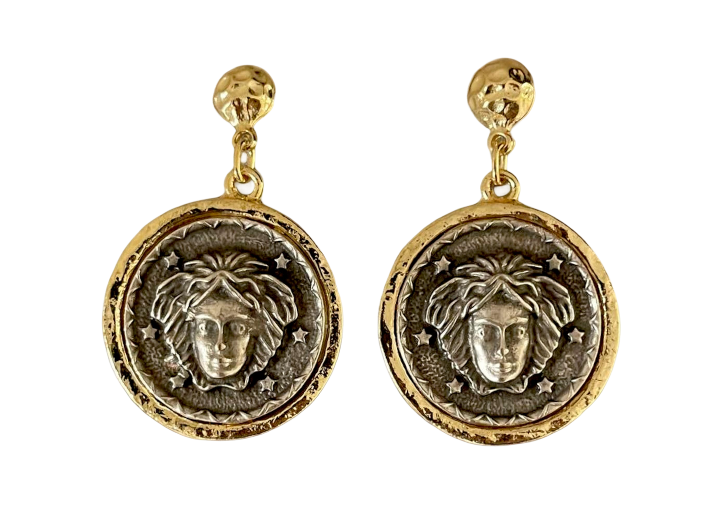 a pair of earrings with a lion head on it