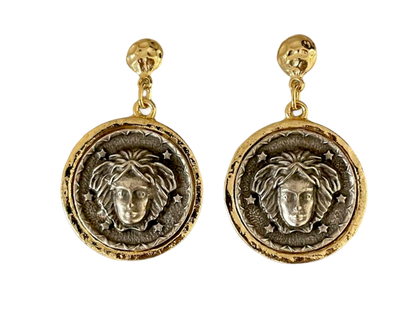 a pair of earrings with a lion head on it