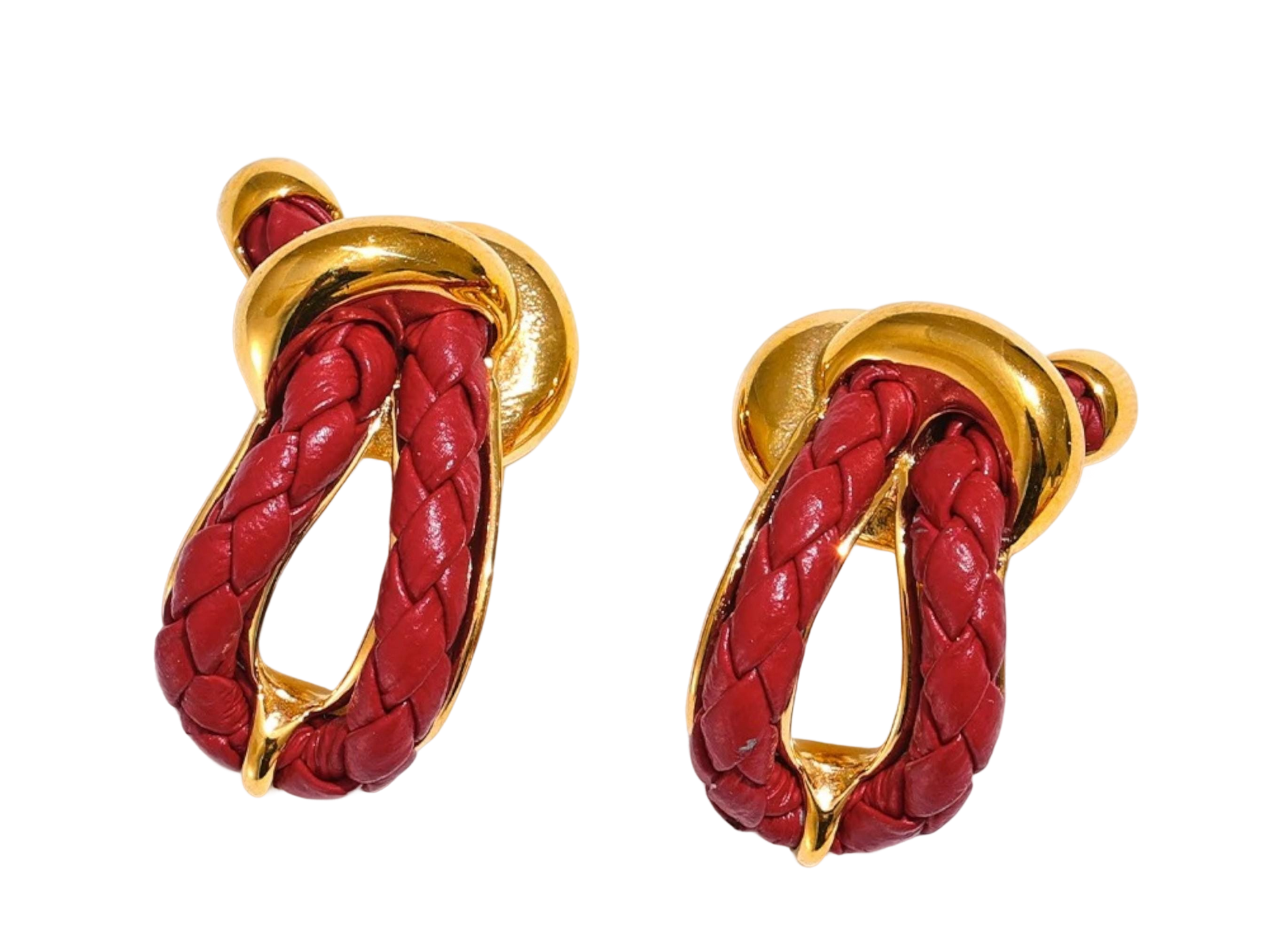 a pair of red and gold earrings on a black background