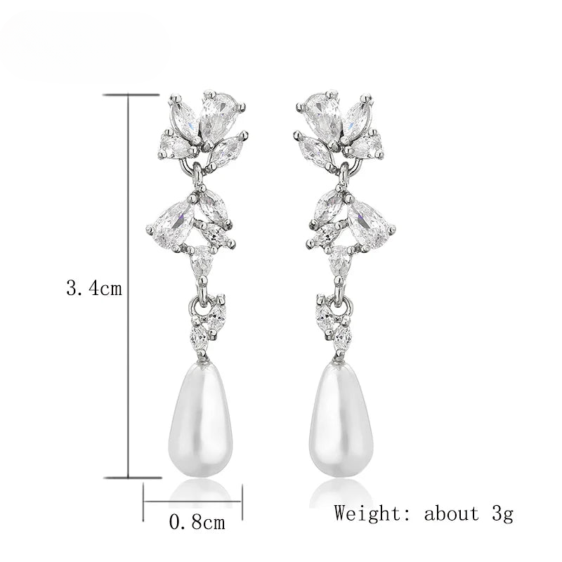 a pair of white pearls and crystal earrings