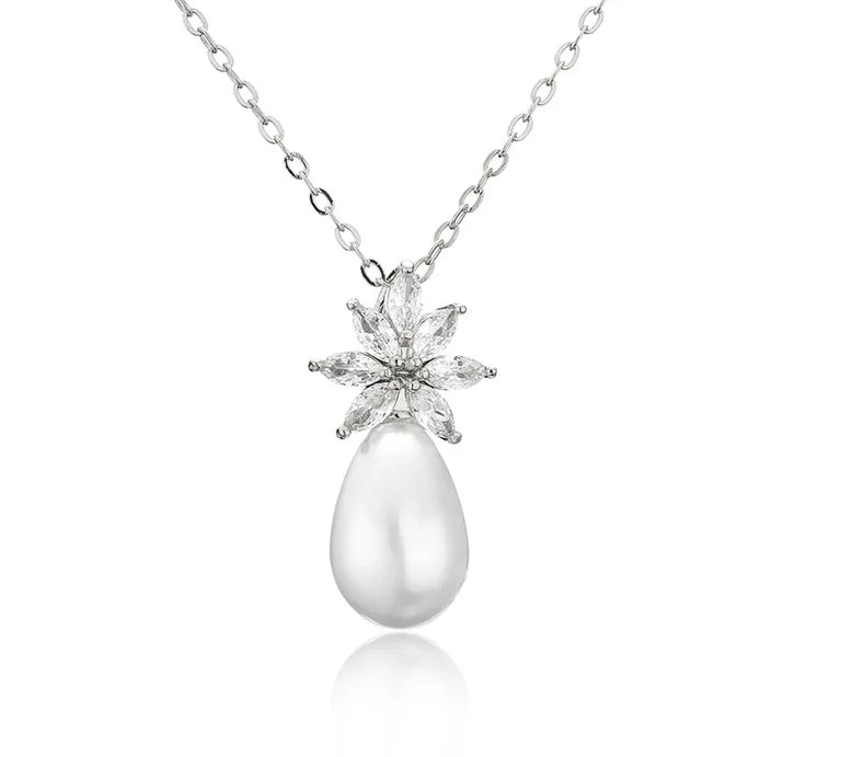 a white pearl and diamond pendant on a chain