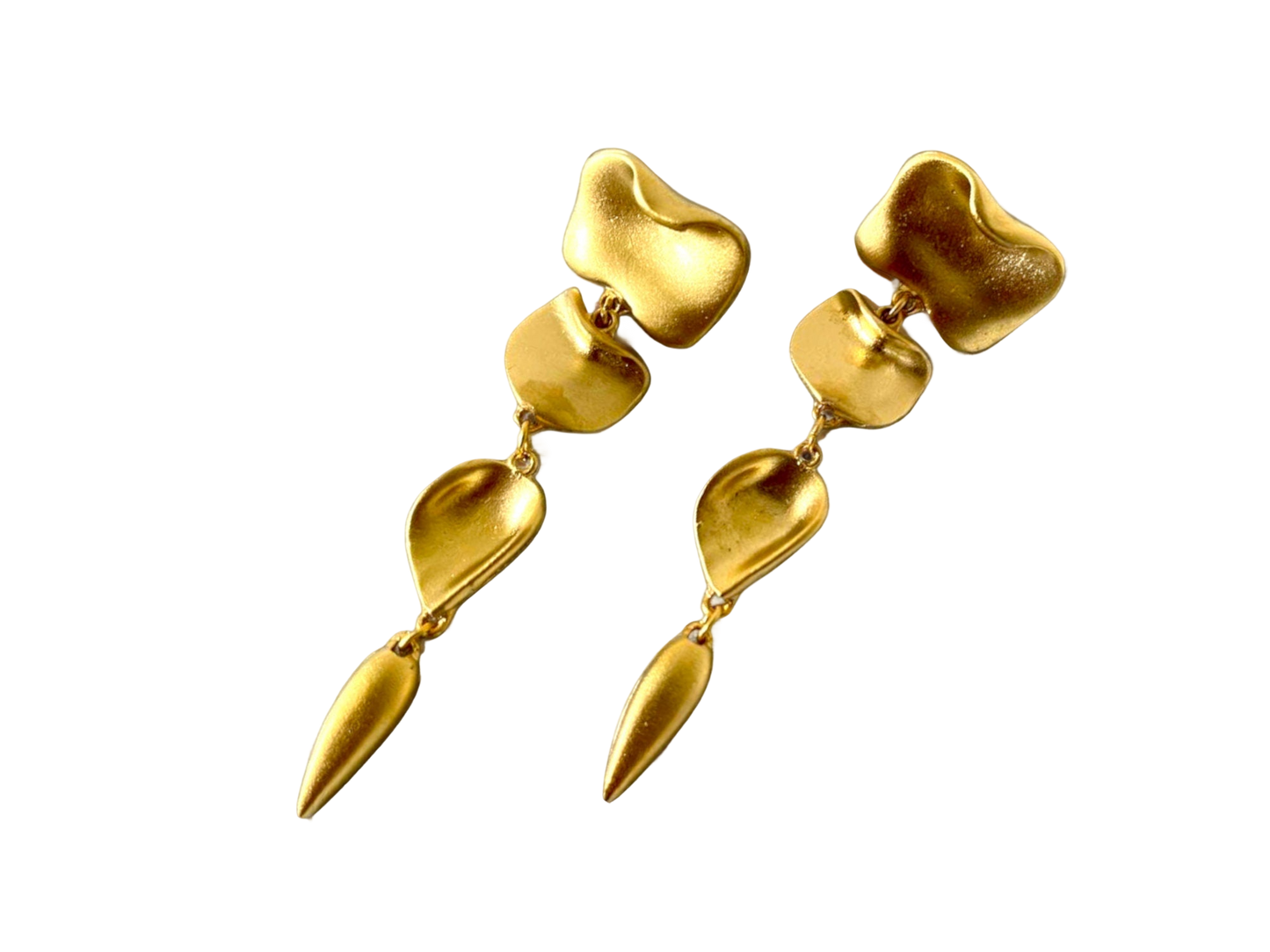 a pair of gold earrings on a black background