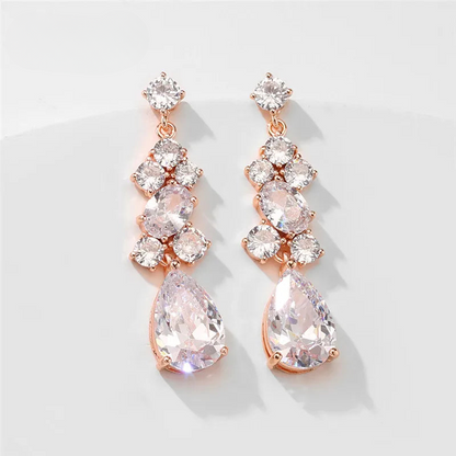 a pair of pink and white earrings on a white surface