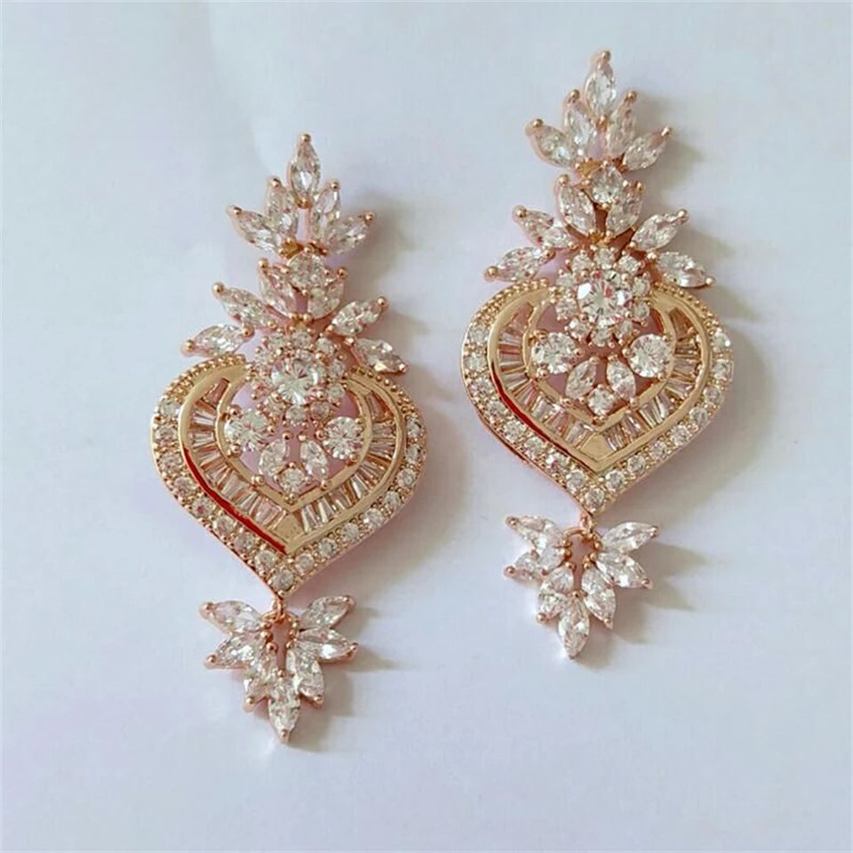 a pair of gold and diamond earrings