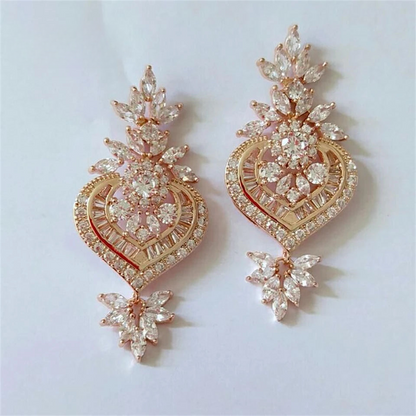 a pair of gold and diamond earrings