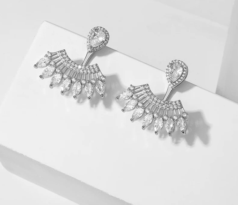 a pair of earrings on a white surface