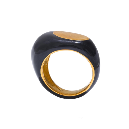 a black and gold ring on a black background