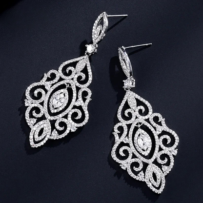 a pair of earrings on a black surface