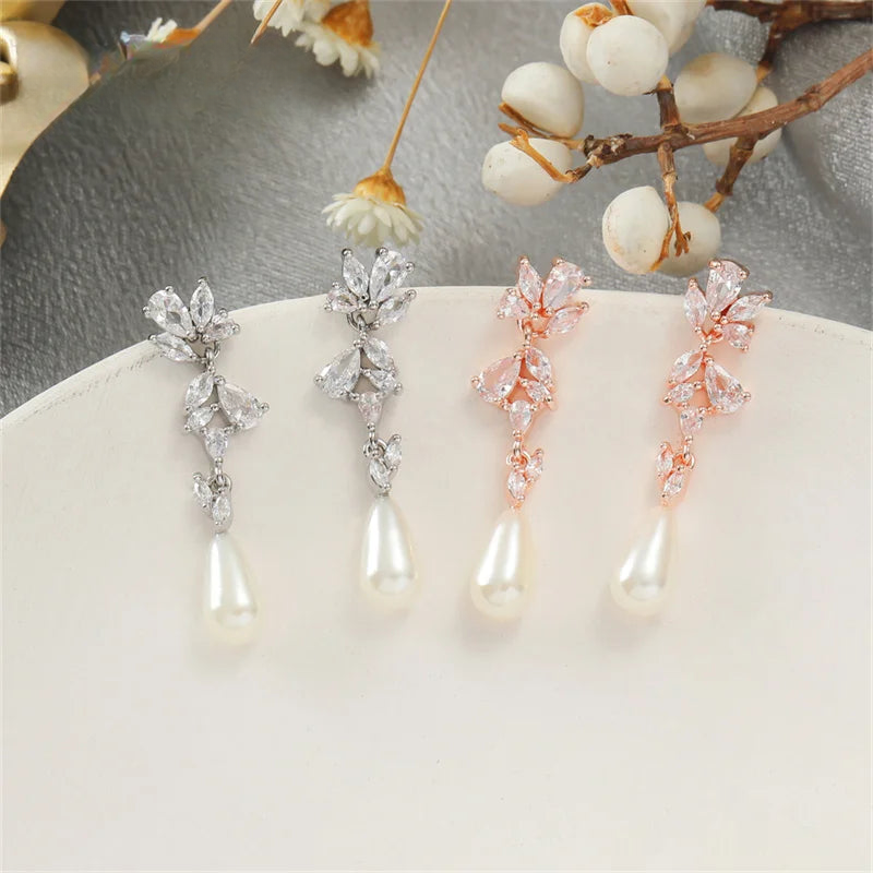 three pairs of pearl and crystal cross earrings