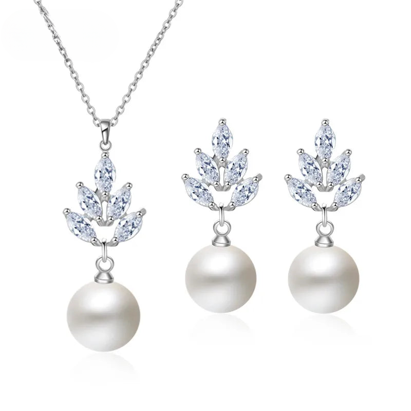 a set of necklace and earrings with pearls