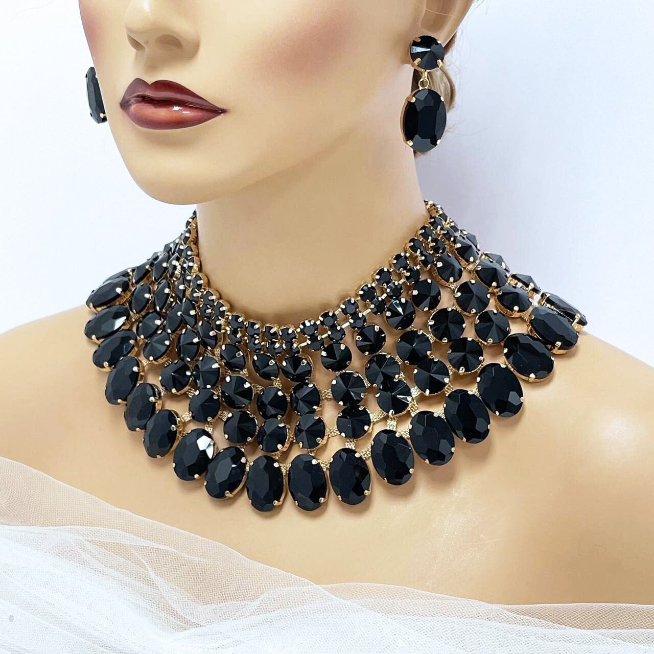 a mannequin with a necklace and earrings on it