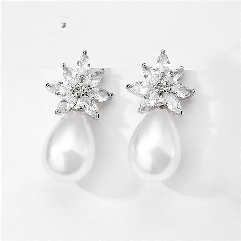 a pair of pearl and crystal earrings