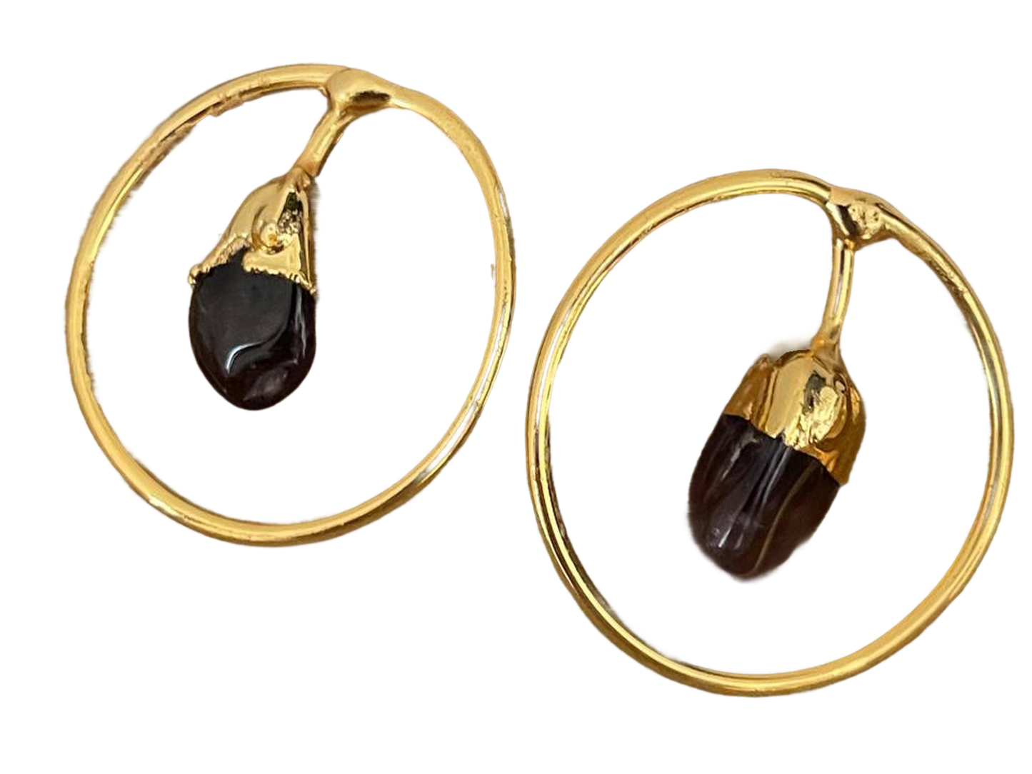 a pair of gold hoop earrings with black stones