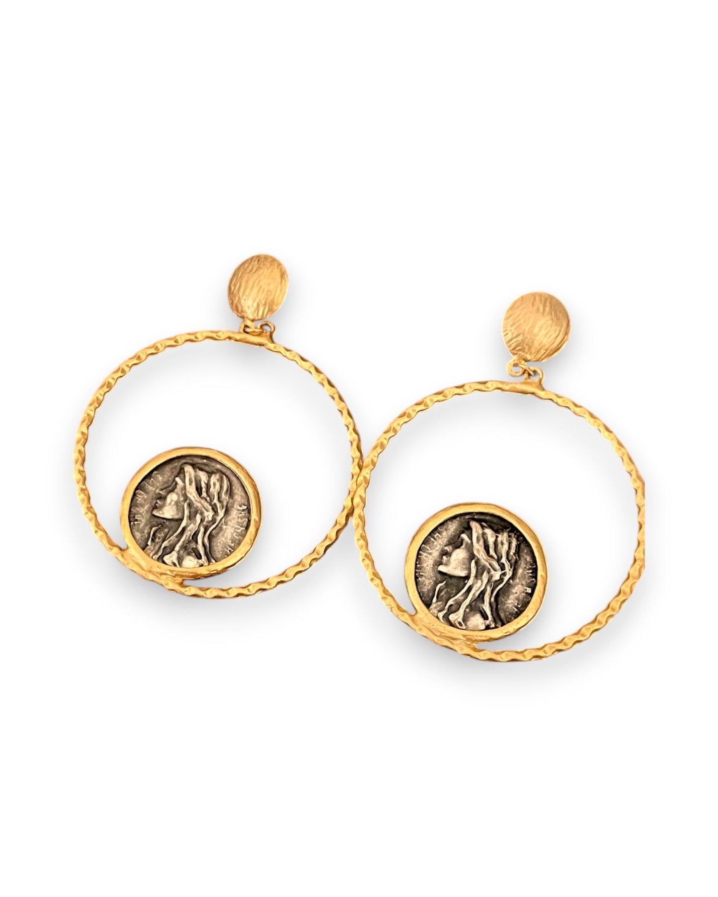 a pair of earrings with a coin in the middle