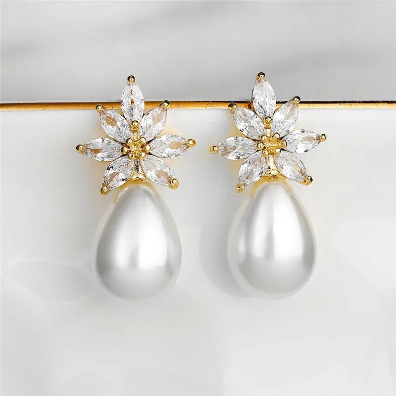 a pair of pearl and diamond earrings