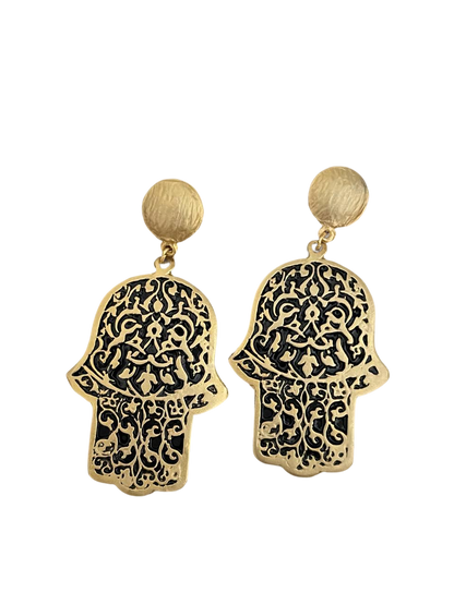 a pair of gold earrings with a hamsah design