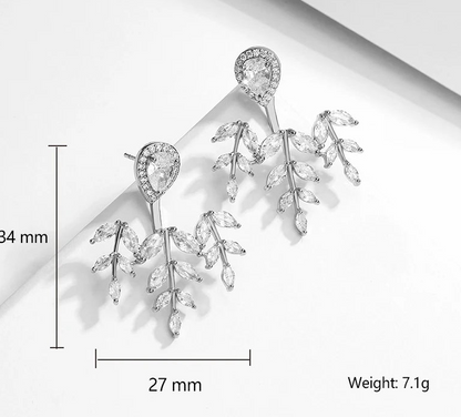 a pair of earrings with crystal stones and leaves