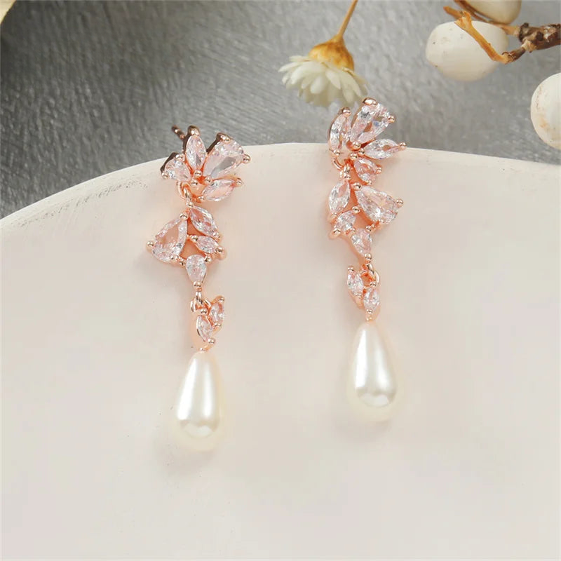 a pair of pearl and crystal earrings