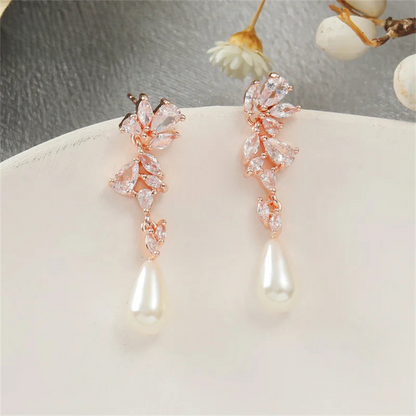 a pair of pearl and crystal earrings