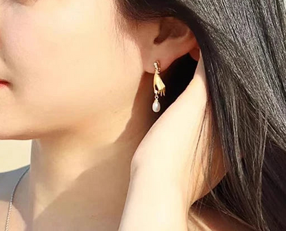 a close up of a person wearing a pair of earrings