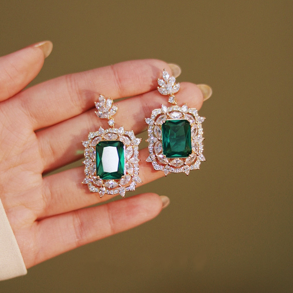 Radiant Green Emerald Geometric Drop Earrings
 
 Discover the elegance and trendiness of our Green Emerald Cubic Zirconia Earrings. Crafted from high-quality copper alloy and adorned with radiant cubic zirconiaGlam DuchessGlam DuchessRadiant Green Emerald Geometric Drop Earrings