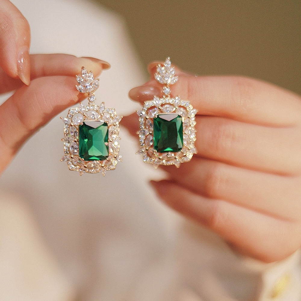 Radiant Green Emerald Geometric Drop Earrings
 
 Discover the elegance and trendiness of our Green Emerald Cubic Zirconia Earrings. Crafted from high-quality copper alloy and adorned with radiant cubic zirconiaGlam DuchessGlam DuchessRadiant Green Emerald Geometric Drop Earrings