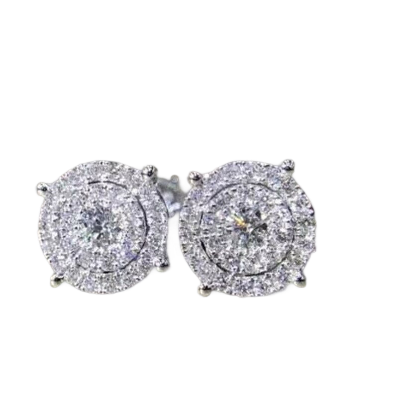 a pair of diamond earrings on a black background