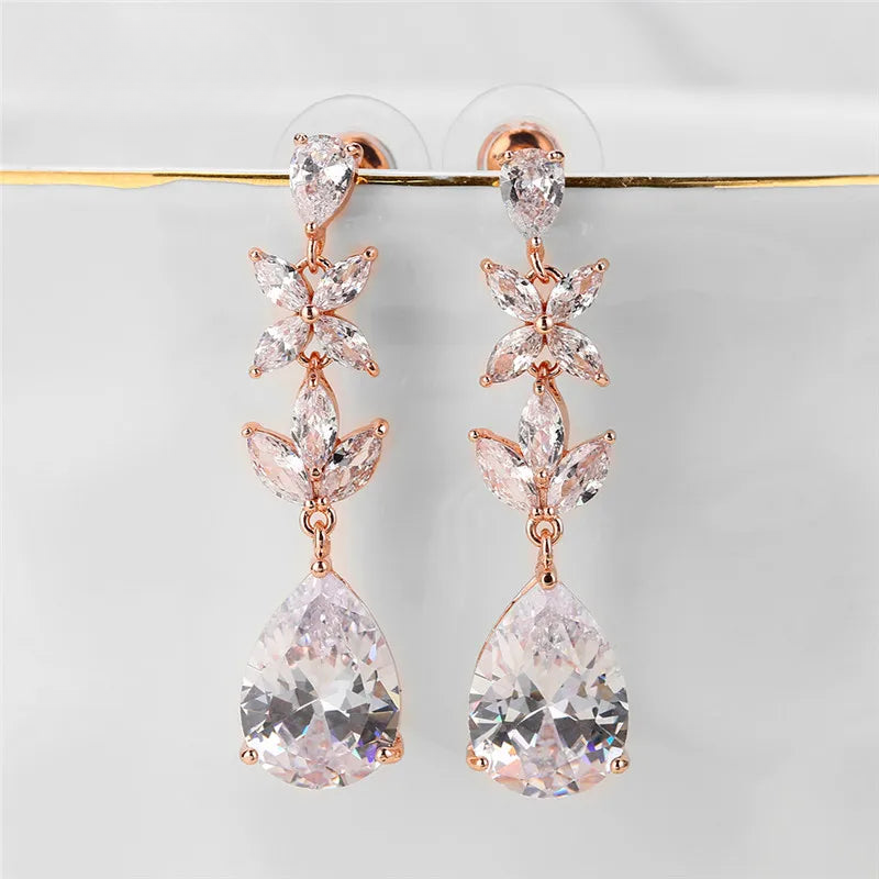 a pair of pink and white earrings hanging from a hook